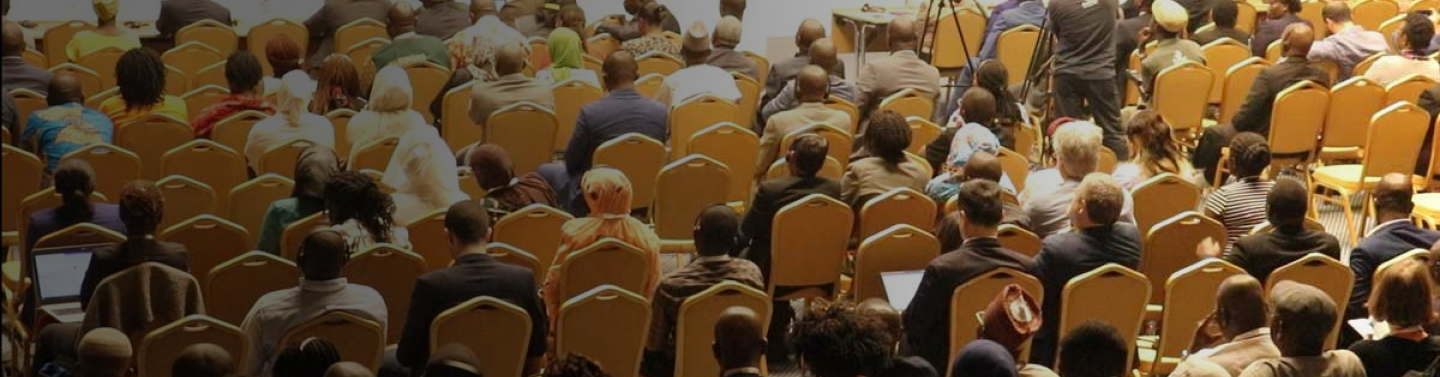 People seated watching a presentation